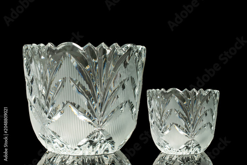 Foto Elegant crystal products isolated on black background, close-up.