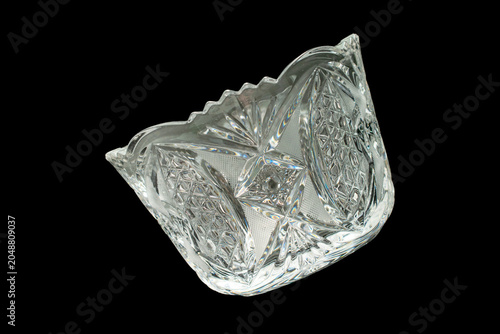 Elegant crystal products isolated on black background, close-up.