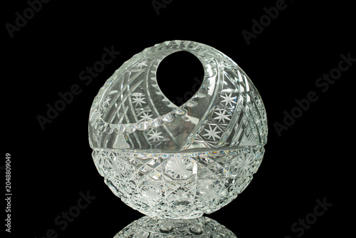 Elegant crystal products isolated on black background, close-up.