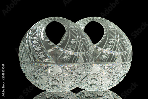 Elegant crystal products isolated on black background, close-up.