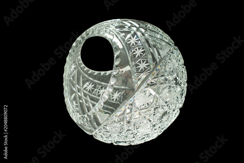 Elegant crystal products isolated on black background, close-up.