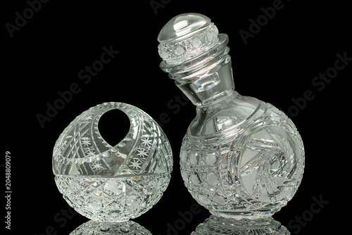 Elegant crystal products isolated on black background, close-up.