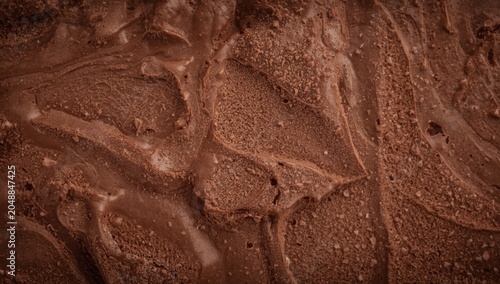 textured background of homemade chocolate ice cream showing smooth and rough areas