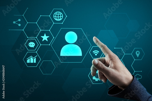 Hand pointing at glowing user profile icon in futuristic hexagonal interface