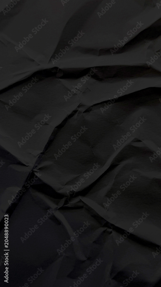 Fototapeta premium Dark black crumpled paper texture background mobile wallpaper