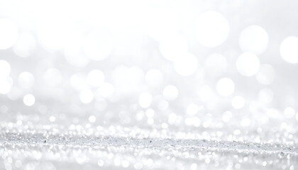 Sparkling bright white bokeh lights and glitter texture, festive abstract background with shallow depth of field, subtle shimmer effect for celebrations and holidays