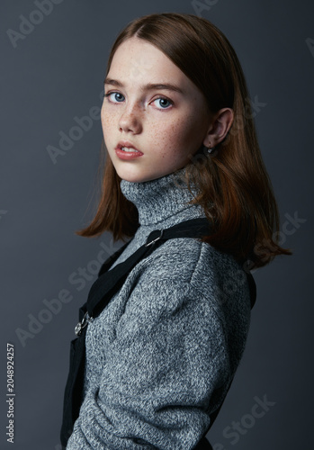 Little girl wearing sweater and sundress. Close-up portrait of sweet child