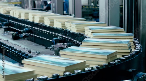 Books move along a conveyor belt in a factory