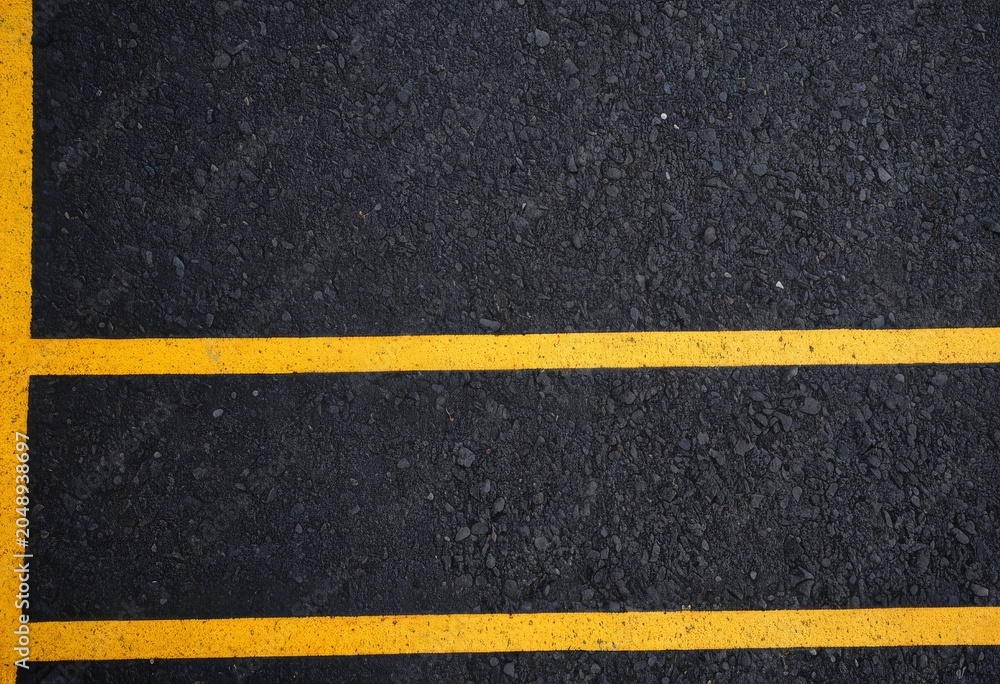 Fototapeta premium Asphalt road texture with yellow center lines