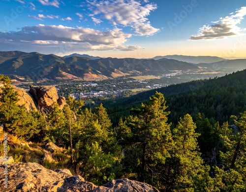 Scenic overlook capturing a valley town surrounded by mountain ranges