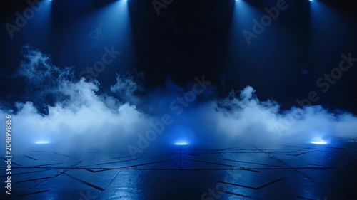 Dark stage with blue spotlights and dense fog.