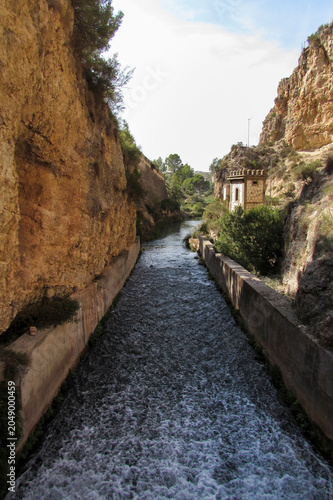 Water canal through a rocky gorge in Camarillas reservoir.