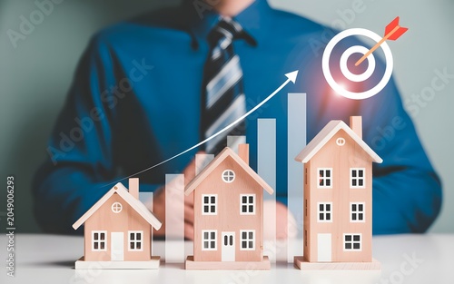 Businessman analyzing a growing real estate market with increasing housing demand and investment goals