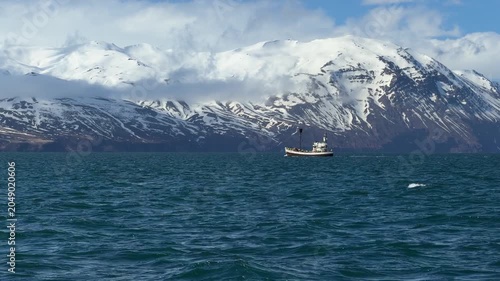 Passenger fishing boat carrying tourists during a whale watching excursion in the waters near Húsavík, Northern Iceland. 