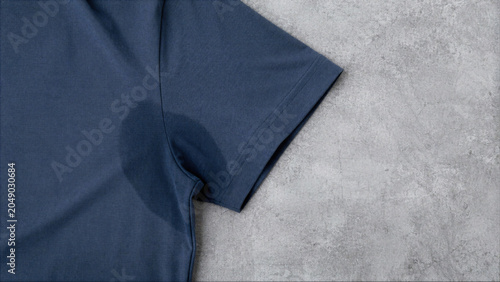 Visible sweat stain on the underarm of a dark blue cotton t-shirt