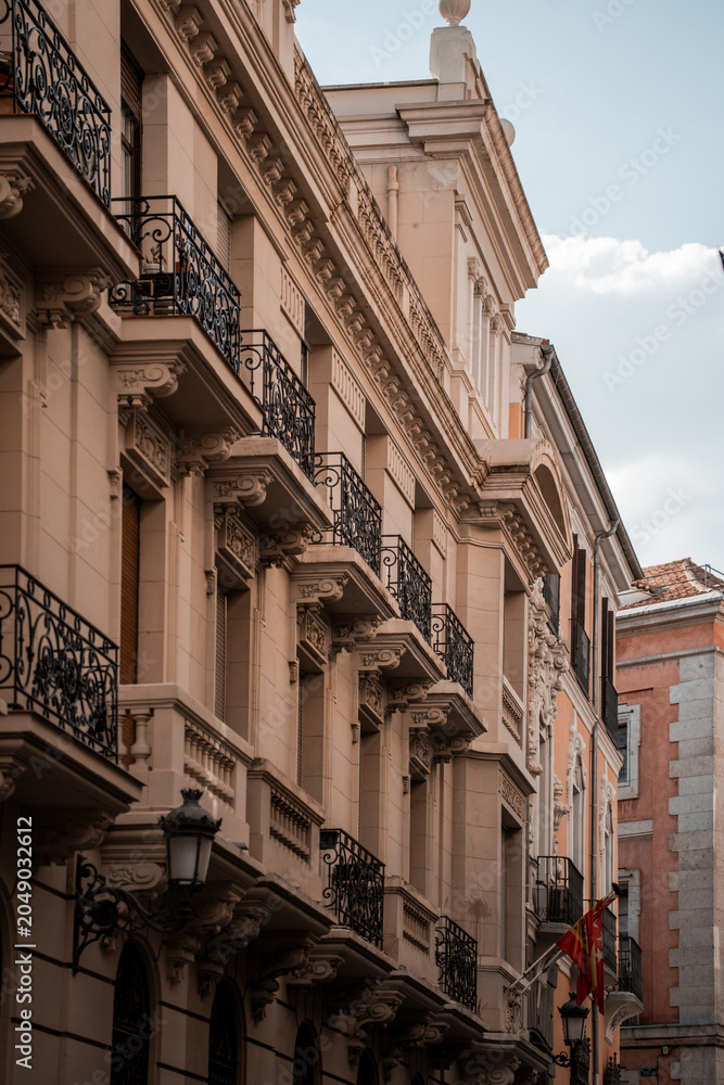 Fototapeta premium Architecture of the city center of Madrid, Spain. Alley and narrow roads with Spanish balconies and design.