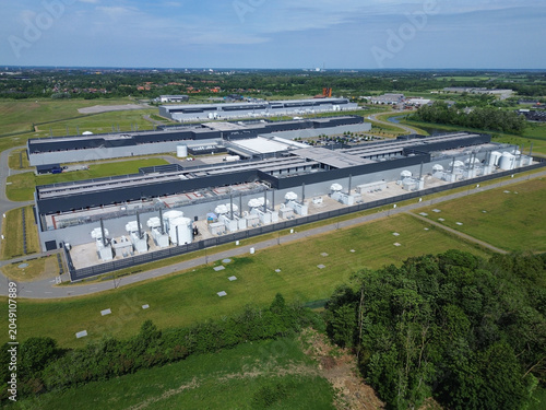 Massive modern data center facility built within the green landscape of Funen island in sunny Denmark.