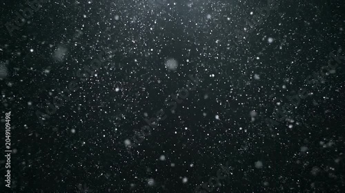 Abstract particles floating and swirling in dark atmospheric background with light rays