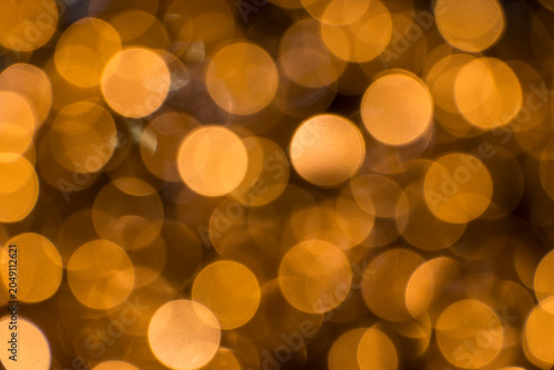 Golden abstract background with blurred lights in closeup