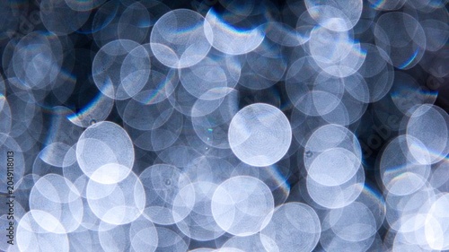Fotografie Abstract luxury background with soft blue and silver bokeh circles glowing on a dark texture