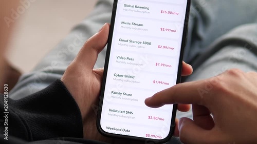 a user reviewing a list of monthly subscription add-ons. The interface shows prices for Global Roaming, Music Stream, and Cloud Storage. Ideal for illustrating billing plans, service customization