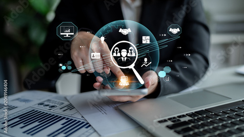 Fotografie Businessman Using Digital Technology for Data Analysis and Strategy Development in Modern Office Environment Fluxor