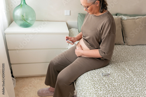 Mature woman self-administering GLP-1 medication