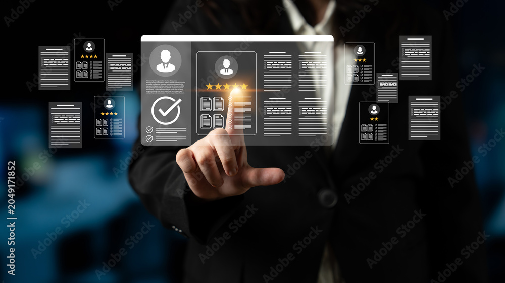 Naklejka premium A business professional interacts with a transparent digital display showcasing data and documents, highlighting modern innovation and technology in an office setting. Ledger