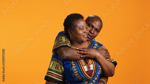 Photos Loving husband embracing his wife in front of camera, showing sincere feelings and true love for his life partner