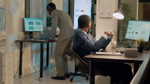 Fotografie African american accountant struggling to concentrate at work because coworker is being too loud while listening to music