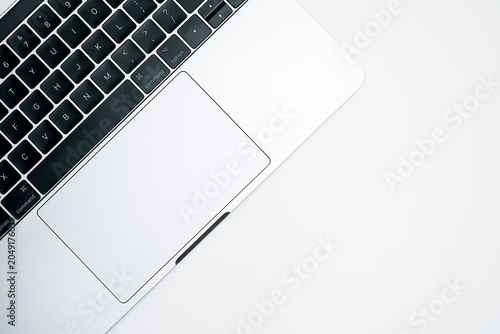 Obraz na płótnie Top view of modern silver laptop keyboard and trackpad isolated on a white backg