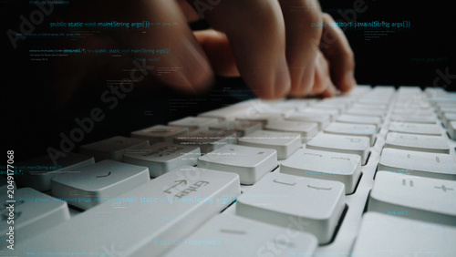 Foto A captivating close-up image of hands actively typing on a sleek keyboard, accompanied by abstract digital code elements, symbolizing the fusion of technology and creativity