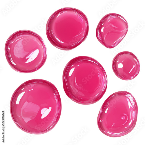 Glossy pink liquid droplets of various sizes are scattered on a white surface, reflecting light and showing smooth, rounded shapes.