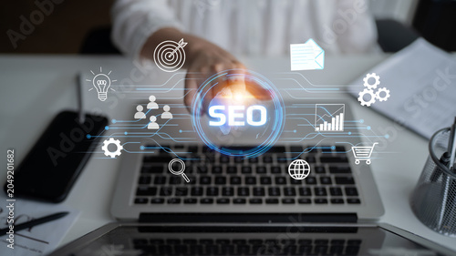 A businessman interacts with a laptop showcasing SEO strategies in a modern workspace  highlighting digital marketing concepts and tools for online growth and optimization. Entropy.