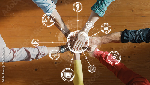 Принти на полотні Hands coming together symbolize teamwork and collaboration in a modern workspace, enhanced by digital icons that represent innovation, creativity, and connection among individuals