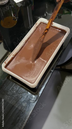 chocolate cake batter is poured into the cake pan