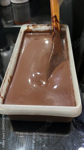 chocolate cake batter is poured into the cake pan