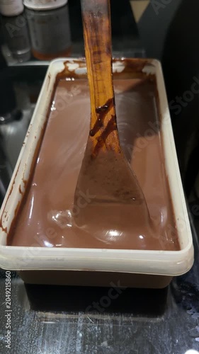 chocolate cake batter is poured into the cake pan