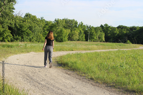 Woman with red hair at the restored tallgrass prairie at Linne Woods in Morton Grove, Illinois