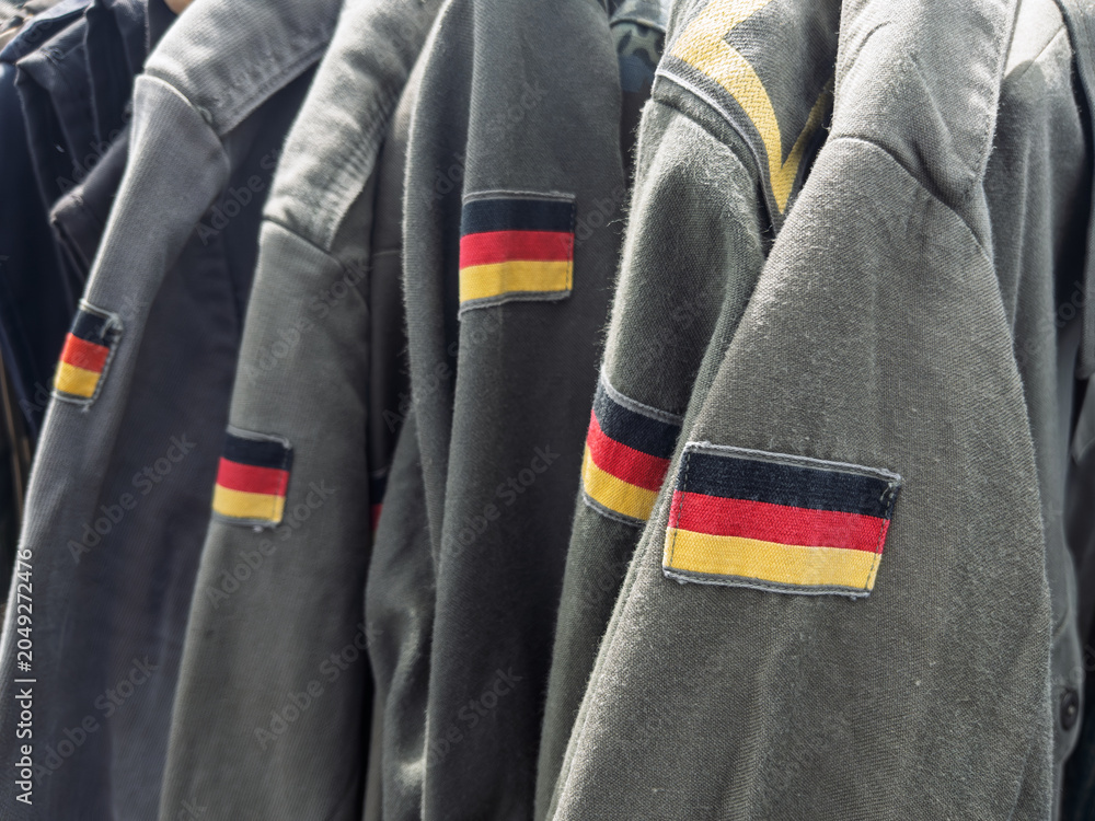 Naklejka premium Vintage German Military Uniforms Displayed for Sale