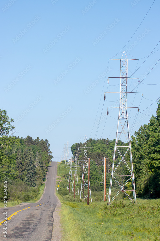 Obraz premium high voltage power lines in the countryside on a sunny spring day