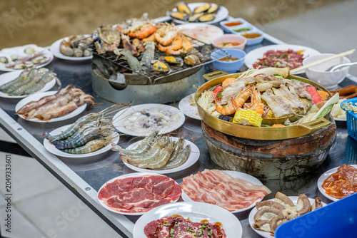Fotografie Grilled food, or Thai-style barbecue like Moo Kratha (Thai-style grilled pork), in buffet style is becoming very popular in Thailand