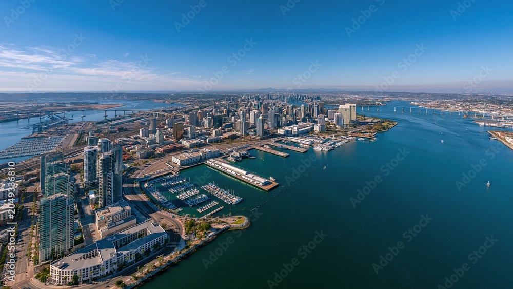 Fototapeta premium Aerial view of modern city skyline and river marina at dusk