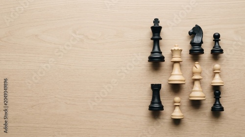 Chess pieces on wooden background with copy space for business strategy concept