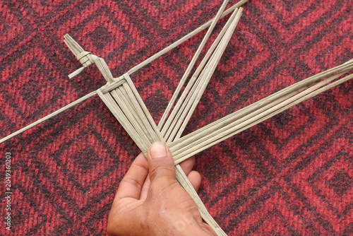 The process of making suket puppets, which are made from a type of grass called mendong