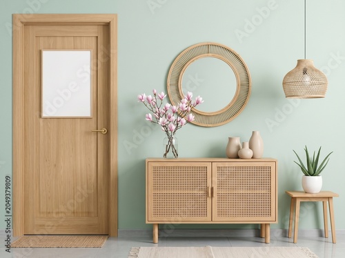 Japandi Style Hallway Decor with Wooden Door, Cane Sideboard, and Green Wall