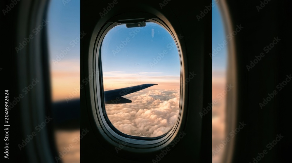 Fototapeta premium Airplane window view of the sky and clouds at sunset