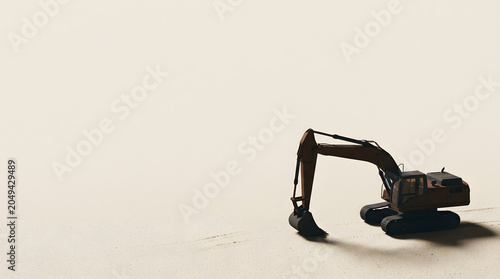 Hydraulic excavator digging on a vast sandy plain.