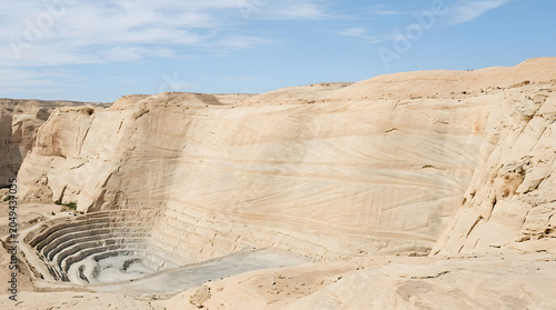 Vast open-pit mine with stepped geological layers.