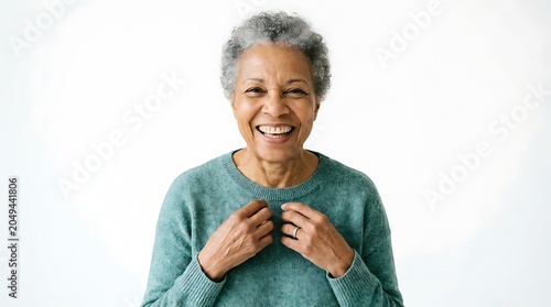 Cheerful senior Black woman laughing joyfully, posing in a teal sweater against a plain white background